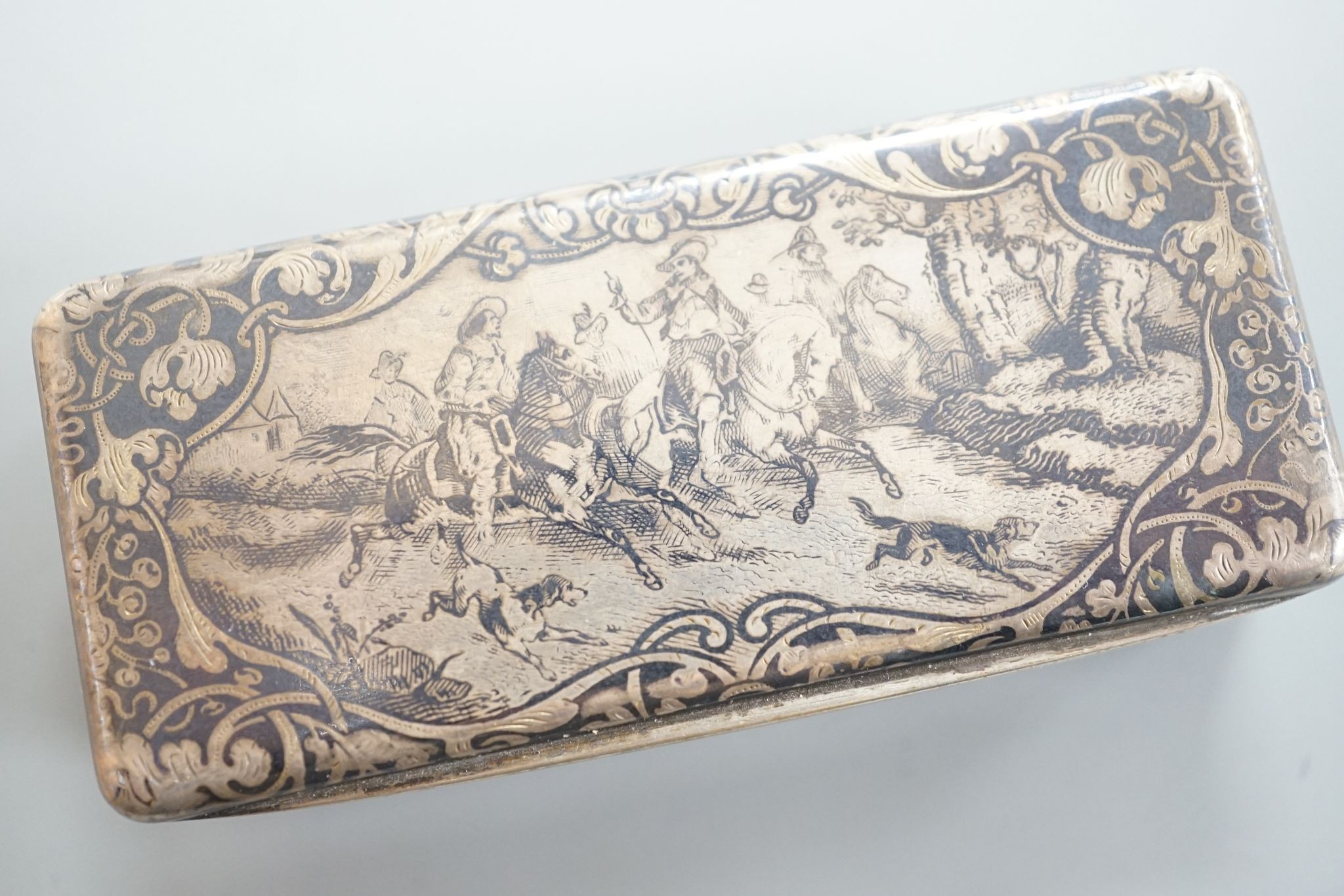 A 19th century French white metal and niello snuff box, 78mm, decorated with hunting scene.